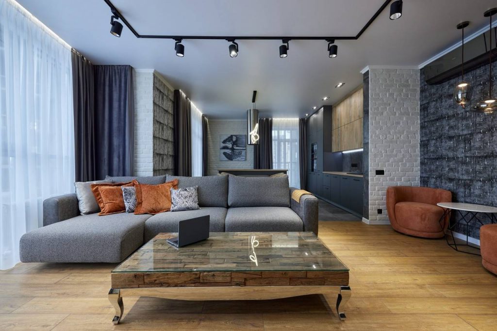 Sala de Estar Industrial com Cimento Queimado, Metal e Tubulações à Vista - inspiração