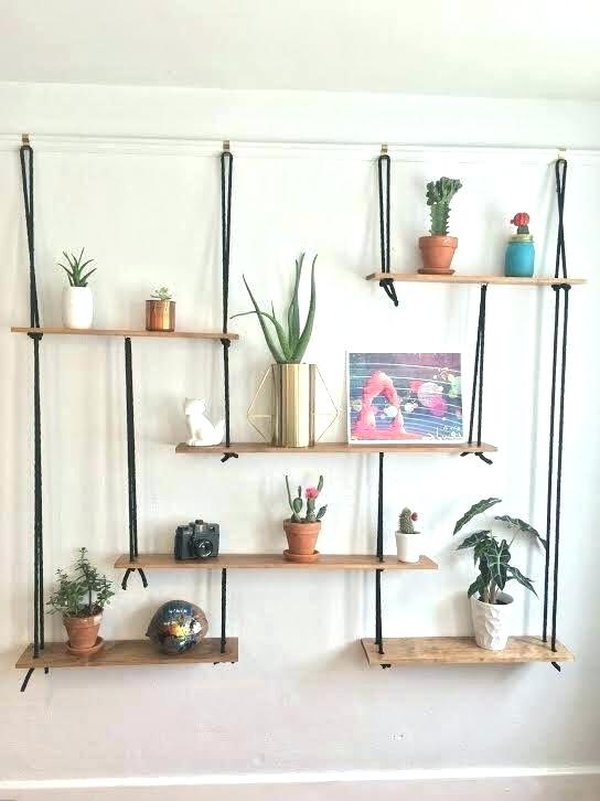 Estante Biblioteca Suspensa com Cordas: Design Inovador e Aéreo - inspiração